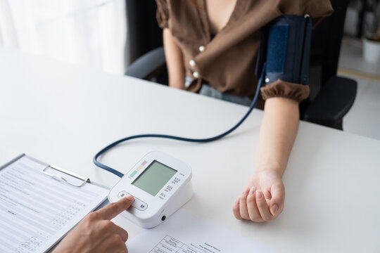 Doctor checking  patient arterial blood pressure. Health care measuring blood pressure of patient
