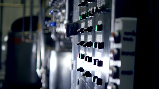 Industrial Control Panel with Illuminated Switches in Factory
