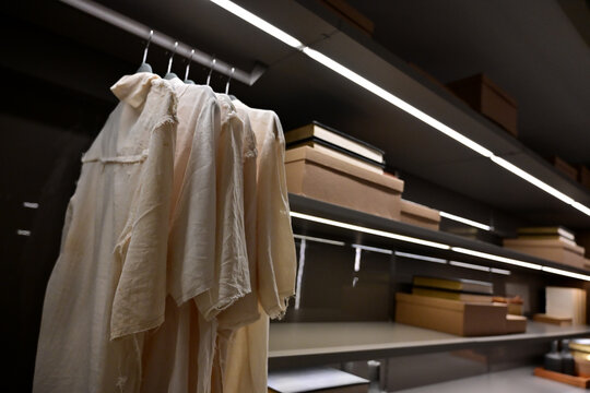 luxury walk in closet with led strip lighting, modern wardrobe storage system with shelves and boxes, elegant bedroom dressing room organization, contemporary domestic interior home furniture