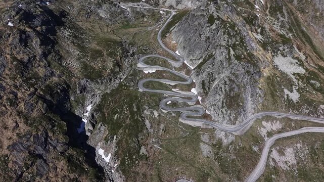 Aerial view of the winding Tremola road with its iconic hairpins carved into the steep rocky mountain slopes to the Gotthard Pass, near Airolo, Ticino, Switzerland.