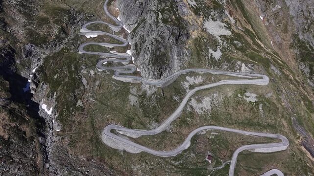 Aerial view of the winding Tremola road with its iconic hairpins carved into the steep rocky mountain slopes to the Gotthard Pass, near Airolo, Ticino, Switzerland.