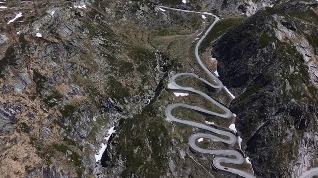 Aerial view of the winding Tremola road with its iconic hairpins carved into the steep rocky mountain slopes to the Gotthard Pass, near Airolo, Ticino, Switzerland.