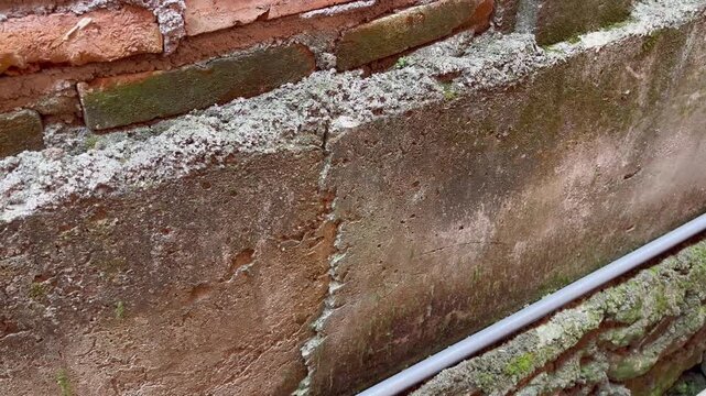 Red Brick Wall Built On Top Of Concrete Foundation