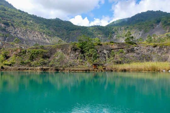 Panguna mine town pit lake with turquoise water and pumping station in Autonomous Region of Bougainville, Papua New Guinea