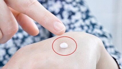 Fototapeta premium Woman Applying Moisturizing Cream on Hand Close Up