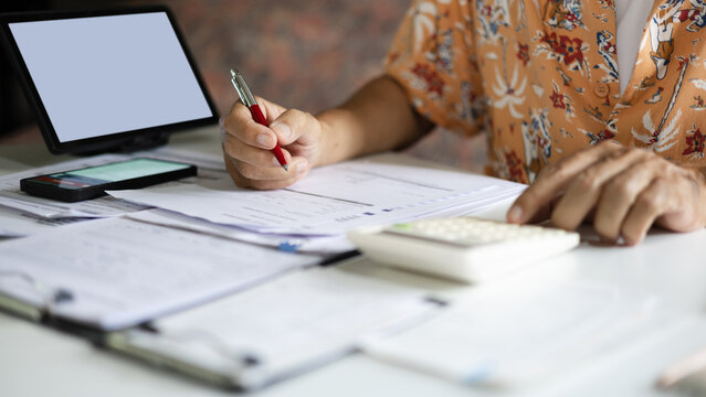 close-up shot, casual man start new business work at home checking receipt calculate expenses. doing online business, E-commerce via digital tablet