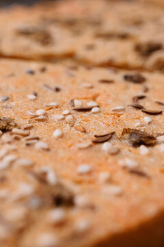 Close-up of freshly baked bread with sesame and cumin seeds on top.