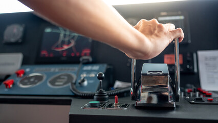 Captain hand holding throttle control or engine control lever on boat dashboard with GPS navigation and marine radar in wheelhouse or ship bridge. Speed adjustment instrument for seafaring technology © zephyr_p