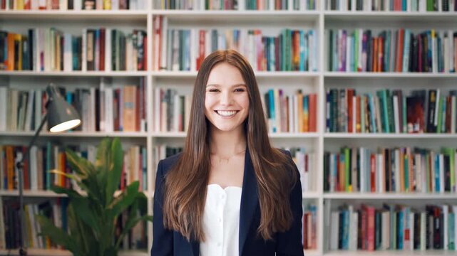 Happy, woman and face of lecturer in library with confidence for career in education by bookshelf. Smile, about us and portrait of female tutor with pride for literature job opportunity at university