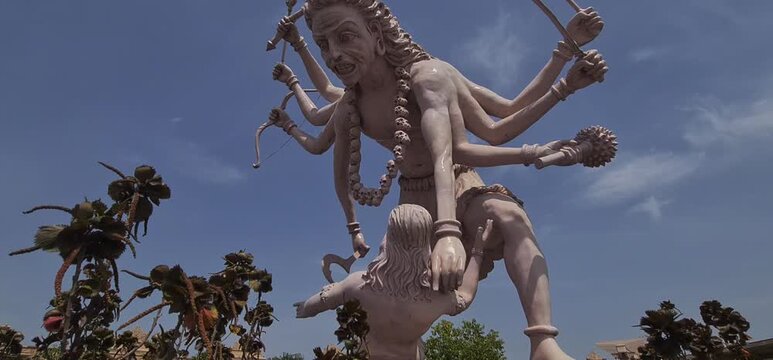Majestic multi armed sculpture of Lord Bhairava ancient fierce form of Hindu God Shiva under blue sky