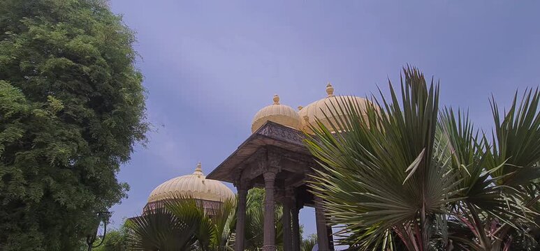 Medieval Period Pavilion with Domes and Tree Branches Swaying in Wind at Ramghat, Ujjain, Madhya Pradesh, India 