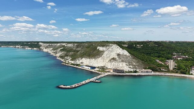 Aerial view of Chirakman Cape with its white limestone cliffs, turquoise waters, and a small pier along the Black Sea coast in Kavarna, Dobrich Province, Bulgaria.