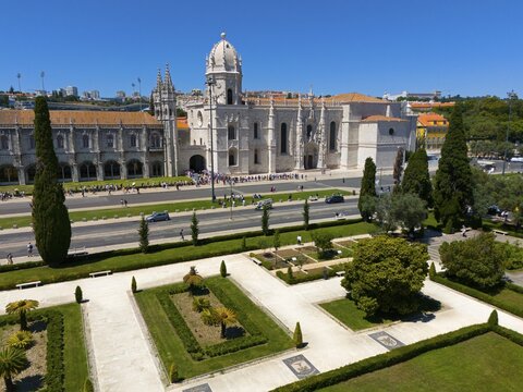 Gothic church with surrounding gardens and green areas next to a street under a clear blue sky, aerial view, Hieronymus Monastery, Mosteiro dos Jer&oacute;nimos, Hieronymite Monastery, World Heritage Site, Monastery Church of Santa Maria, Bel&eacute;m, Belem, Bethlehem, Lisbon, Lisboa, Portugal