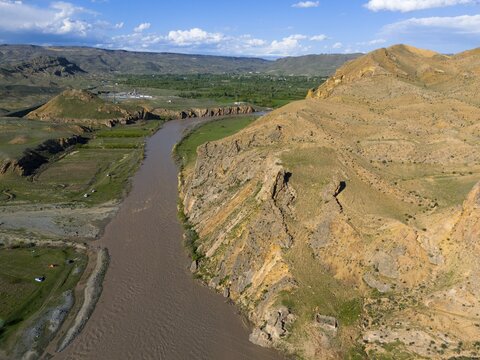 River between steep cliffs under blue sky with scattered clouds, aerial view, Aras River, mountains on D70 and D80, Tuzluca, Igdir Province, Iğdır, Eastern Anatolia, Anatolia, Turkey