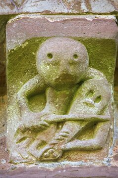 Norman Romanesque exterior corbel no. 44, sculpture of a fiddle or rebeck player, by the Hereford School of Romanesque Stonemasons, Church of St Mary and St David, Kilpeck, Herefordshire, England, United Kingdom