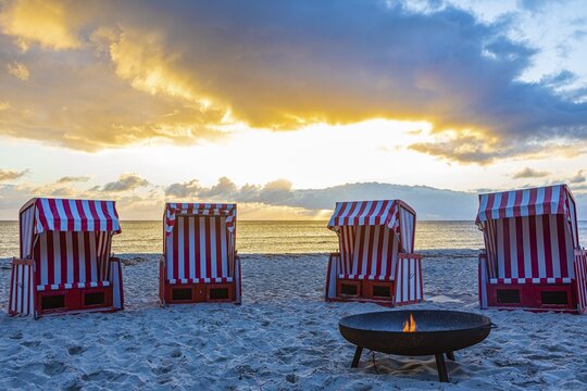 Beach chairs and fire bowl at sunrise at the big beach of Thiessow, island R&uuml;gen, Baltic Sea, Mecklenburg-Western Pomerania, East Germany