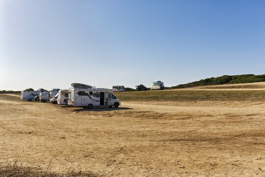 Various motorhomes and campervans on a car park, camping, free standing, Sardinia, Italy