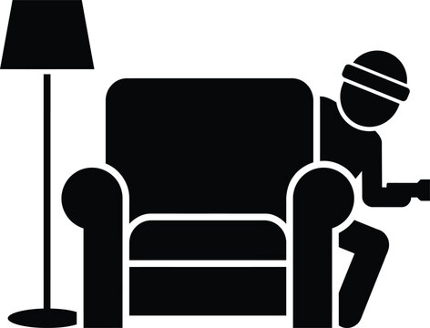 Silhouette of person hiding with gun behind armchair, crime concept
