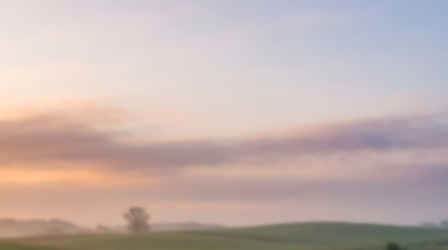 Dream and Sunrise for inspirational quote poster theme. Misty sunrise over rolling green hills beneath pastel clouds