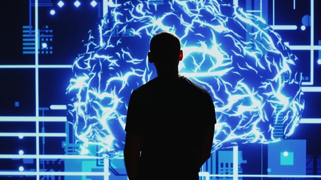Engineer looks at neural network projection to ensure machine learnign big data processing, artificial intelligence development. AI brain deep learning and cloud computing science. Handheld shot.