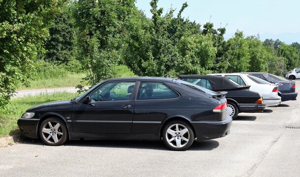 Tavagnacco. Italy. May 31, 2026. Vintage Saab cars at the roadside. Saab 9-3 coupe on foresight,&nbsp; behind a&nbsp; Saab 900 Cabriolet and other models.