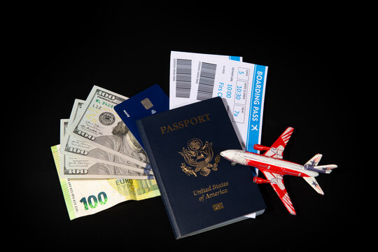 US passport with boarding pass and money for travel. American travel passport with cash and credit card. Travel and money for trip. American passport and tickets with US dollars for travel.