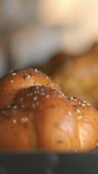 Vertical video: Shifting lens focusing on seeded braid on tray, showing seeds for glossy crust