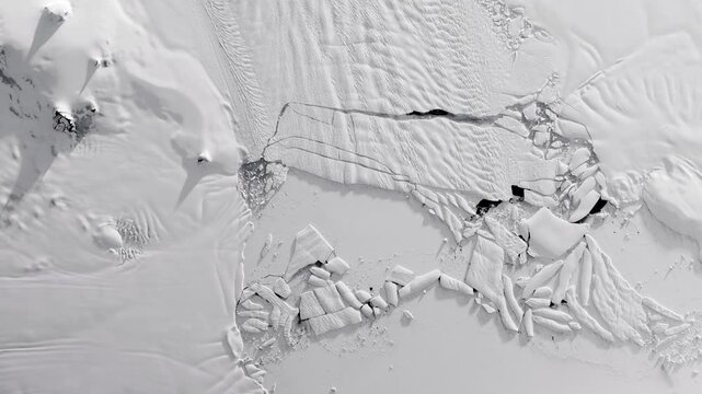 Panoramic top view of glacier flowing into sea, cracking in pieces making icebergs. Camera is moving forward. Animation based on image by NASA