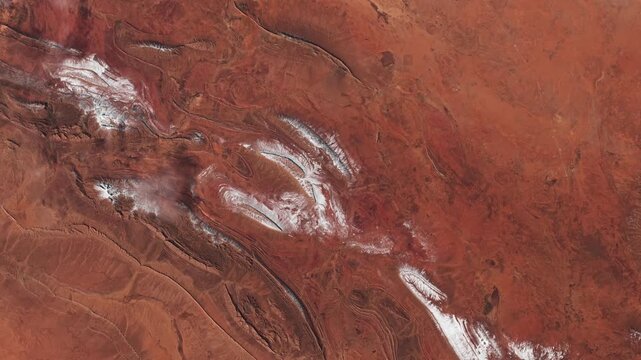 Panoramic shot on red rocky desert with prints of erosion in dry area. Mars concept. Camera is moving backward and right. Animation based on image by NASA