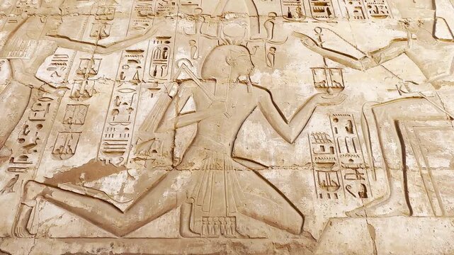 Beautiful bas-reliefs and ancient hieroglyphs from the mortuary temple of Ramesses III at Medinet Habu, Luxor, Egypt