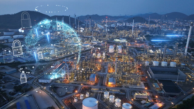 Glowing digital globe and security padlocks overlaid on a petrochemical refinery plant at night. Industrial cybersecurity, OT network protection, and global energy infrastructure defense.