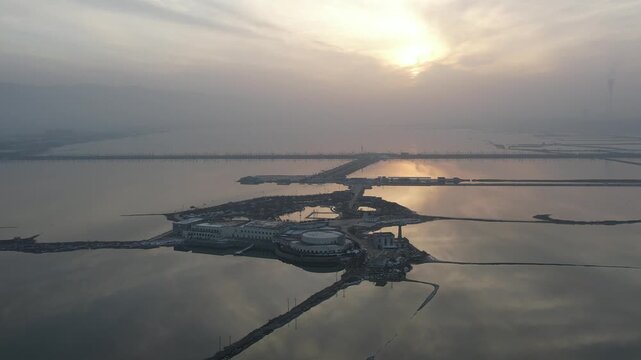 Aerial Sunrise Over Reflective Coastal Salt Ponds and Dikes