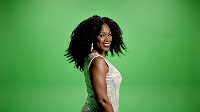 Black woman in sequin dress turning and smiling on green screen background female