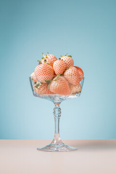 Minimalist crystal bowl with white pineberries.