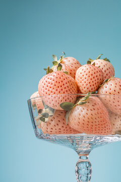 Close up Elegant glass compote dish full of fresh pineberries