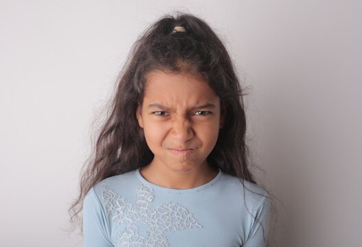 Annoyed young girl making an angry face