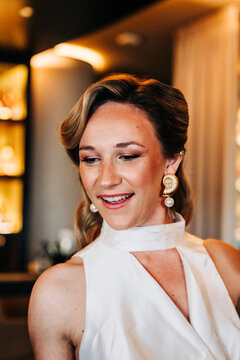 Woman smiling showing nautilus shell pearl earrings