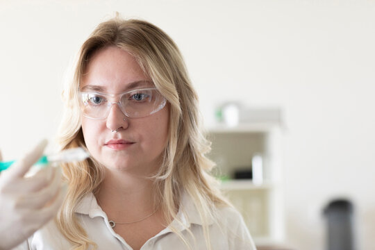 Scientist female with blonde hair working in a labor