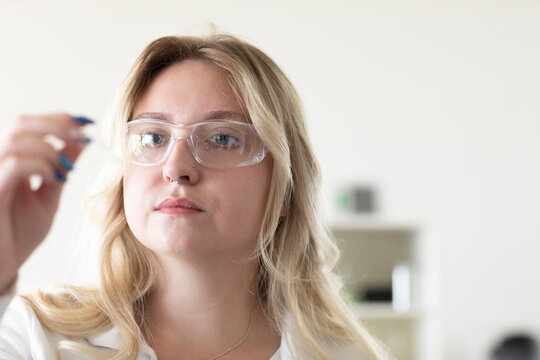 Scientist female with blonde hair working in a labor