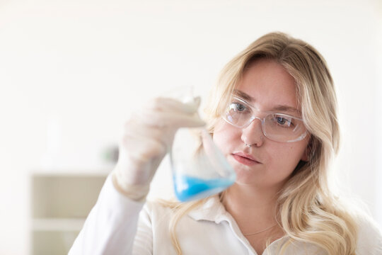Scientist female with blonde hair working in a labor
