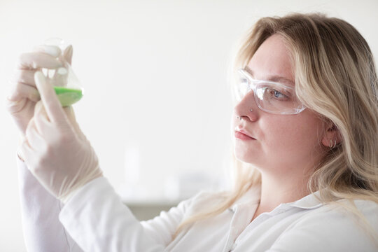 Scientist female with blonde hair working in a labor
