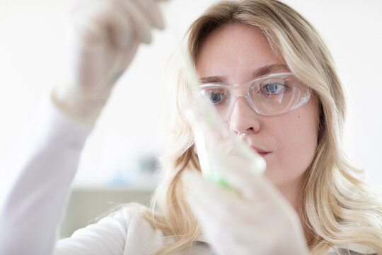 Scientist female with blonde hair working in a labor