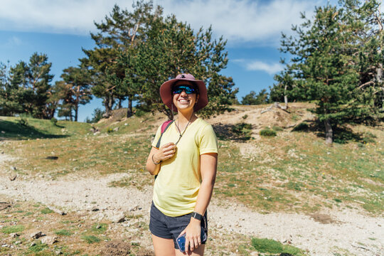 Happy young woman hiking on a sunny day