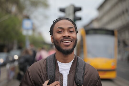 Young happy Black man smiling on a city street