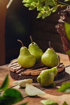 The Packham pear is a popular pear variety known for its sweet flavor, high juiciness, and soft texture. Photographed in a dark mood for a dramatic and beautiful look.