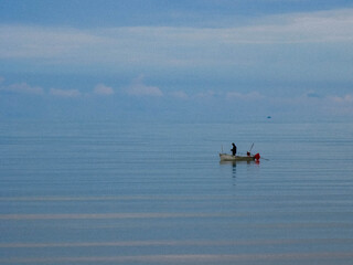 Naklejka premium In a world of endless noise, the smallest boat reminds us that courage is not measured by size, but by the willingness to keep moving across the unknown.