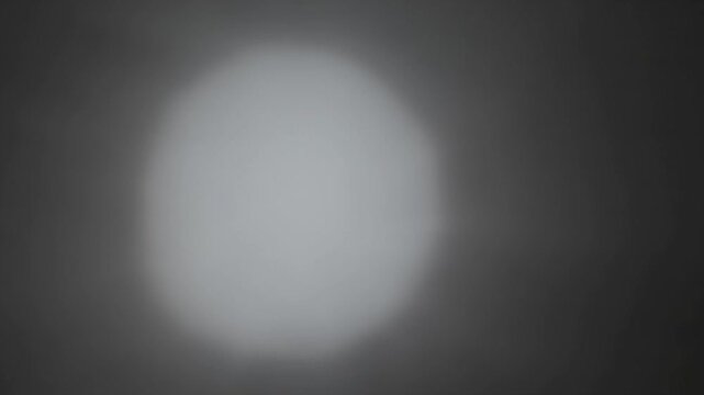 Round Haze Pulse That Grows Unevenly, Giving a Lopsided Glow