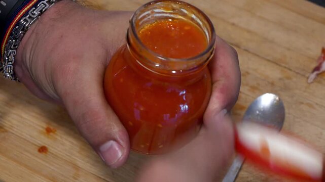 Person preparing a tomato bruschetta appetizer