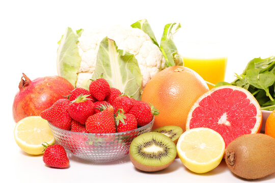 assorted fresh fruits and vegetables with strawberry, kiwi, grapefruit, lemon, cauliflower and orange juice