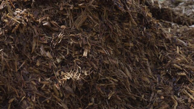 Close up look while panning left across a Mulch Pile.